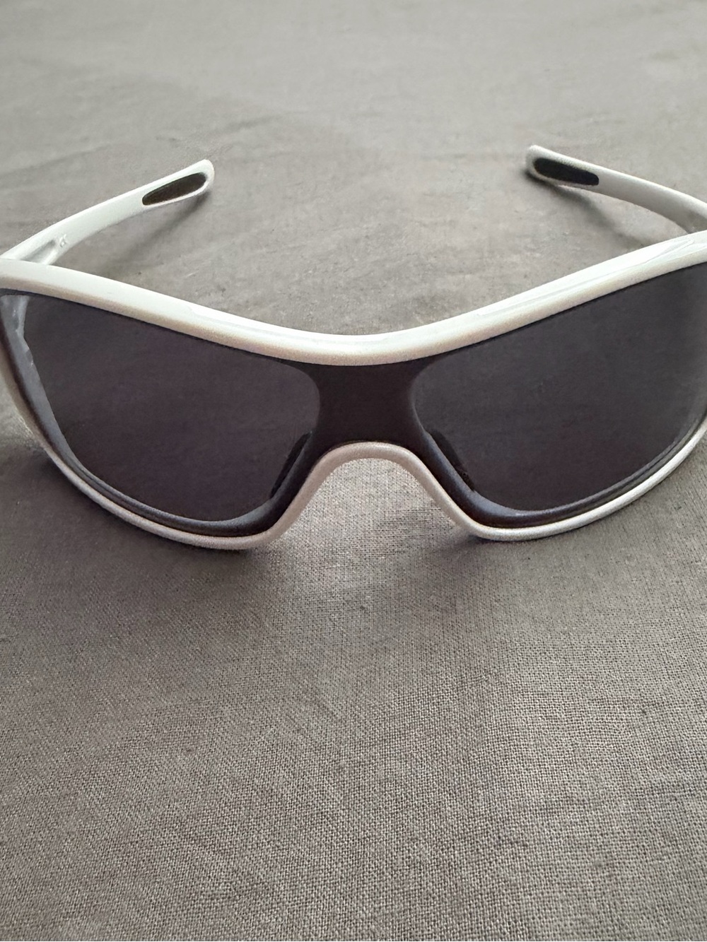 Women's Oakley Ideal white frame sunglasses.